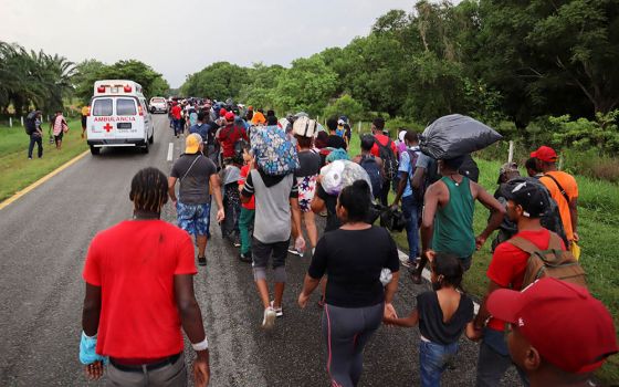 Migrants from Central America and the Caribbean walk in a caravan near Escuintla, Mexico, Aug. 29. They were headed to Mexico City to apply for asylum and refugee status. (CNS/Reuters/Jose Torres)