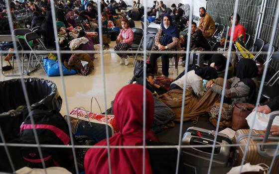 Afghan refugees are processed at Ramstein Air Base Sept. 8 in Germany. (CNS/Olivier Douliery, pool via Reuters)