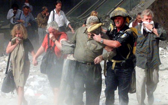 People walk away from the World Trade Center tower in New York City Sept. 11, 2001. (CNS/Reuters/Shannon Stapleton)