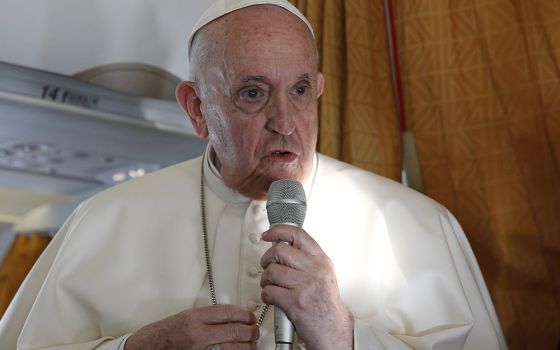 Pope Francis answers questions from journalists aboard his flight Sept. 15 from Bratislava, Slovakia, to Rome. (CNS/Paul Haring)