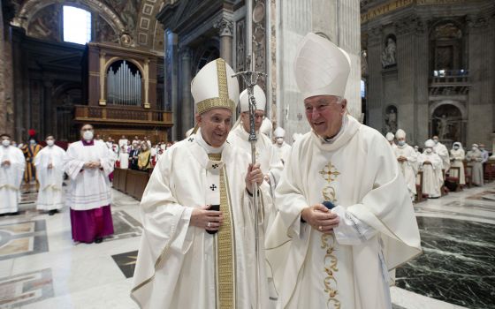 Pope Francis and Cardinal Vincent Nichols of Westminster, vice president of the Council of European Bishops' Conferences, smile during the opening Mass of the plenary assembly of the Council of European Bishops' Conferences in St. Peter's Basilica at the 