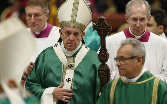 Pope Francis carries his pastoral staff as he leaves the concluding Mass of the Synod of Bishops for the Amazon at the Vatican Oct. 27, 2019. The pope plans to celebrate a Mass Oct. 10, 2021, to formally open the synodal process for the Synod of Bishops i