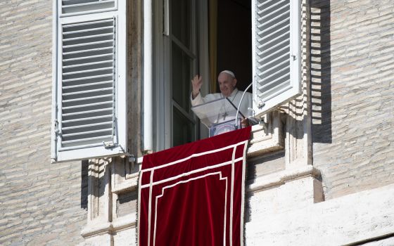 Pope Francis greets the crowd as he leads the Angelus from the window of his studio overlooking St. Peter's Square at the Vatican Oct. 10, 2021. (CNS photo/Vatican Media)