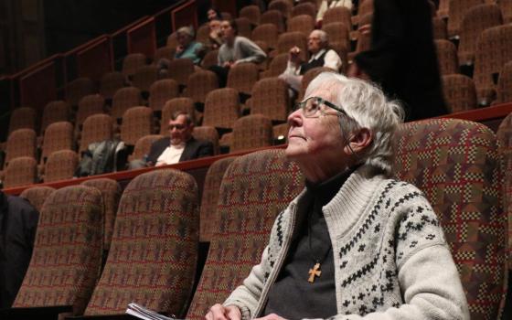 Sister Megan Rice, a member of the Society of the Holy Child Jesus, looks up at the movie screen in the DeBartolo Performing Arts Center April 8, 2018, at the University of Notre Dame in South Bend, Ind., awaiting the screening of a documentary about her 