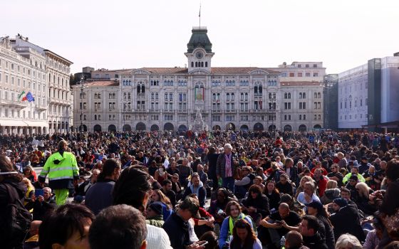 People protest against the implementation of the coronavirus disease "green pass" in the workplace in demonstration at the Unity of Italy Square (Piazza Unita d'Italia) Oct. 18, 2021. (CNS photo/Borut Zivulovic, Reuters)