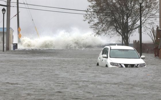 Waves crash over rocks near a submerged vehicle along Maryland's Chesapeake Bay during a Nor'easter in North Beach Oct. 29, 2021. (CNS/Bob Roller)