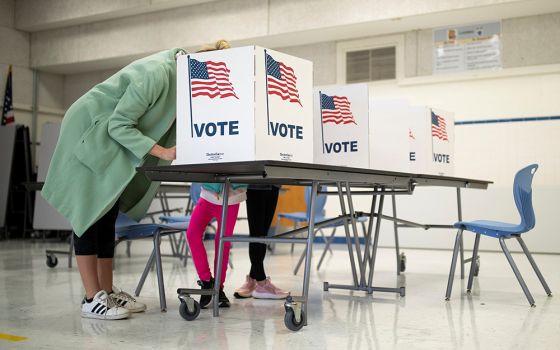 A mother in McLean, Virginia, casts her vote during the governor's race Nov. 2, 2021. (CNS/Reuters/Tom Brenner)