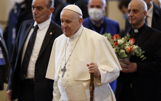 Pope Francis carries a pilgrim's staff as he arrives for a meeting with the poor at the Basilica of St. Mary of the Angels in Assisi, Italy, Nov. 12, 2021. (CNS photo/Paul Haring)