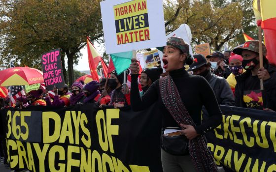 A woman holding a sign shouts during a protest in Washington Nov. 4, 2021, in response to the civilian casualties and abuses caused as a result of a yearlong war in Ethiopia's Tigray region.  (CNS photo/Leah Millis, Reuters)