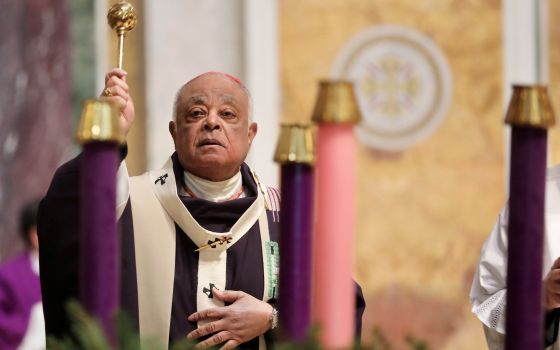 Washington Cardinal Wilton D. Gregory sprinkles holy water to bless the Advent wreath during Mass at St. Matthew's Cathedral Nov. 28, 2021, the first Sunday of Advent. (CNS photo/Andrew Biraj, Catholic Standard)