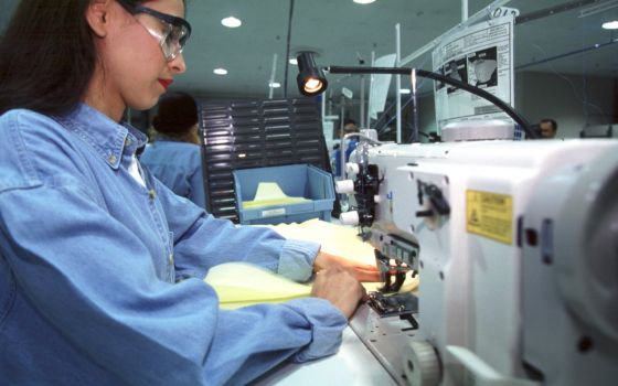 A worker sews air bags for Ford at Aguirre Safety Technologies in Detroit Aug. 12, 2004. (CNS photo/Jim West)