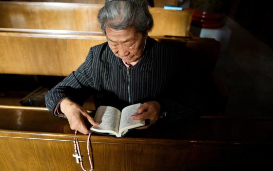 A person reads the Bible during Mass at St. Joseph's Church in Beijing