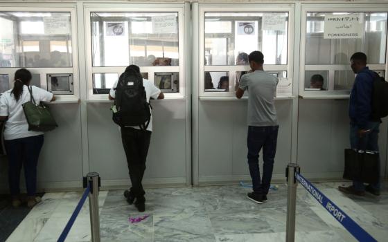 Passengers are processed at the immigration section after arriving at Asmara International Airport in Asmara, Eritrea, July 18, 2018. Eritrean authorities are continuing to detain Catholic Bishop Fikremariam Hagos Tsalim of Segheneity, who was arrested at the airport Oct. 15, 2022. (CNS photo/Tiksa Negeri, Reuters)