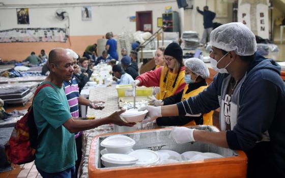 Franciscans in São Paulo serve meals to the homeless and hungry to Brazilians in a shelter May 19, 2022.  