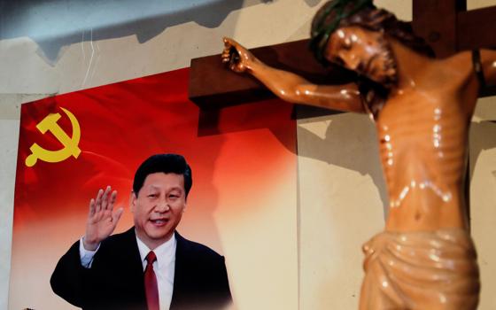 A poster of Chinese President Xi Jinping hangs next to a crucifix on the wall of the house of a Tibetan Catholic in Niuren village, in China's Yunnan province, in 2018. (CNS/Reuters/Tyrone Siu)