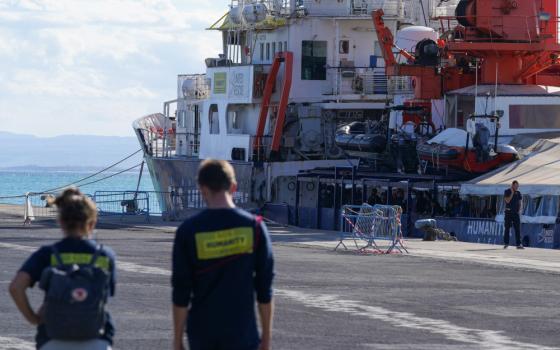 People stand onboard the NGO rescue ship Humanity 1 after Italy allowed the disembarkation of children and sick asylum-seekers in Catania, Italy, Nov. 7, 2022. 