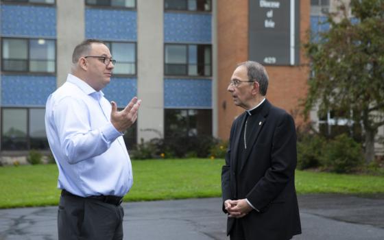 Bishop Lawrence T. Persico of Erie, Pa., speaks with Jim VanSickle of Pittsburgh, who told a Pennsylvania grand jury he was molested by a priest when he was a teenager in Bradford, Pa. VanSickle and the bishop spoke during an Aug. 21, 2018, news conference held in front of the Diocese of Erie's headquarters by members of the Survivors Network of those Abused by Priests, or SNAP.