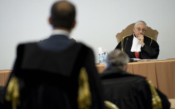 Vatican Judge Giuseppe Pignatone listens during the third session of the trial of six defendants -- including Cardinal Angelo Becciu -- accused of financial crimes at the Vatican City State criminal court Nov. 17, 2021. (CNS photo/Vatican Media)