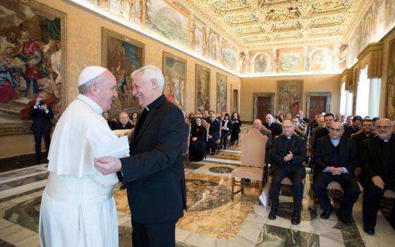 Pope Francis embraces Father Arturo Sosa Abascal, superior general of the Society of Jesus, during a meeting with editors and staff of the Jesuit-run magazine, La Civilta Cattolica, at the Vatican Feb. 9, 2017. (CNS photo/L'Osservatore Romano, handout)