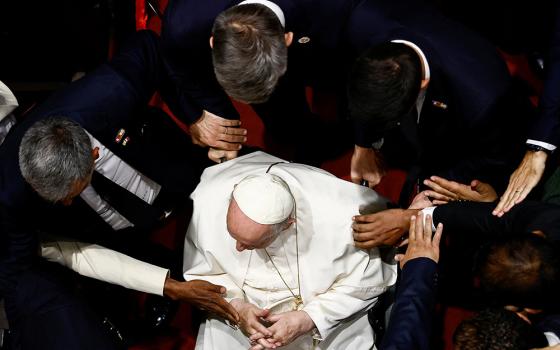 People reach out for Pope Francis during an ecumenical prayer service for peace Nov. 4, at Our Lady of Arabia Cathedral in Awali, Bahrain. (CNS/Reuters/Yara Nardi)