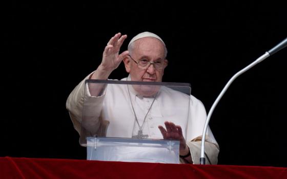 Pope Francis waves to visitors and pilgrims gathered in St. Peter's Square at the Vatican for the recitation of the Angelus prayer Dec. 26, the feast of St. Stephen. (CNS/Vatican Media)