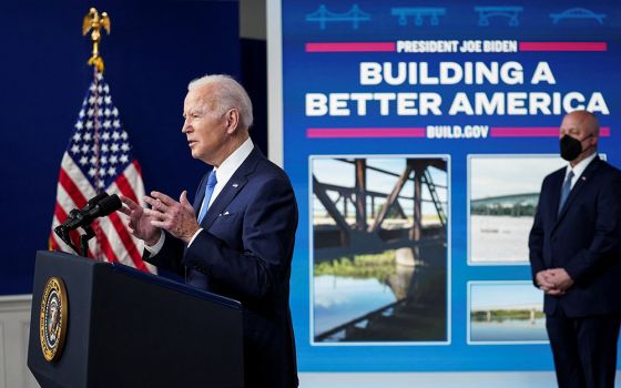 President Joe Biden delivers remarks at the White House in Washington Jan. 14. Also pictured is Mitch Landrieu, senior adviser on infrastructure. (CNS/Reuters/Kevin Lamarque)