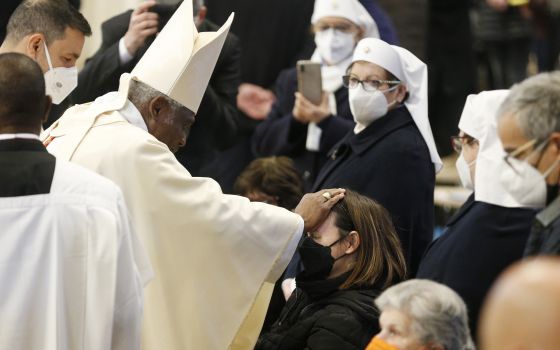 Cardinal Peter Turkson, former prefect of the Dicastery for Promoting Integral Human Development, blesses a woman as he celebrates Mass marking World Day of the Sick, in St. Peter's Basilica at the Vatican Feb. 11, 2022. (CNS photo/Paul Haring)