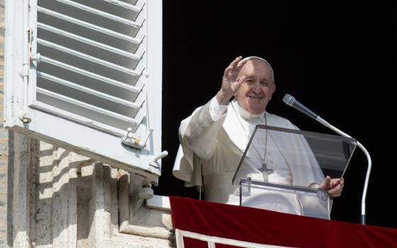 Pope Francis greets the crowd as he leads the Angelus from the window of his studio overlooking St. Peter's Square at the Vatican Feb. 13, 2022. (CNS photo/Vatican Media)