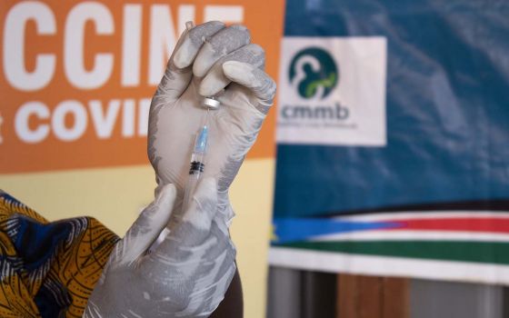 In this undated photo, a staff member with the Catholic Medical Mission Board prepares to administer a COVID-19 vaccination. (CNS photo/courtesy CMMB)