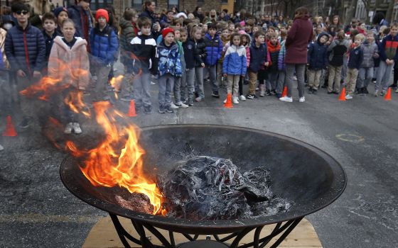 Palms burn at St. Clement School on Shrove Tuesday in Chicago March 1, 2022, during a prayer service for peace in the Ukraine. (CNS photo/Karen Callaway, Chicago Catholic