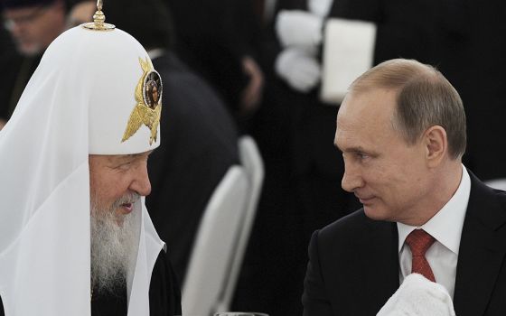 Russian President Vladimir Putin, right, listens to Russian Orthodox Patriarch Kirill of Moscow during a reception at the Kremlin in Moscow in this July 28, 2015, file photo. (CNS)