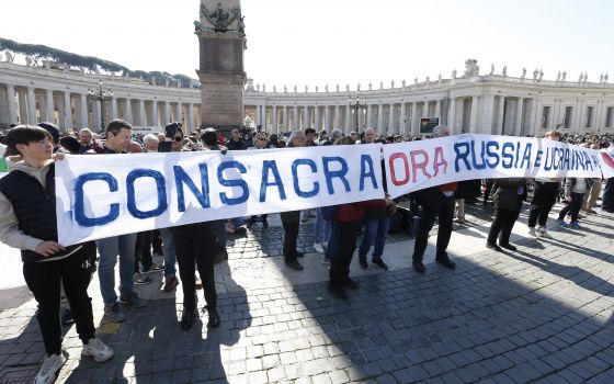 A sign in St. Peter's Square calls for the consecration of Russia and Ukraine to Mary, before the start of Pope Francis' Angelus at the Vatican March 13, 2022. (CNS photo/Paul Haring)