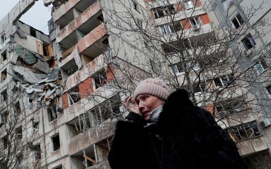 A woman reacts in front of destroyed apartment buildings March 17 in Mariupol, Ukraine. (CNS/Reuters/Alexander Ermochenko)