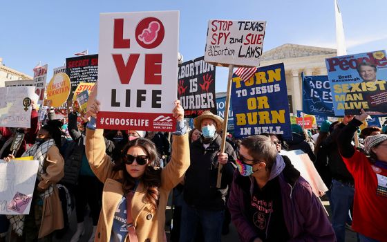 Demonstrators are seen outside the Supreme Court Dec. 1, 2021, ahead of oral arguments in Dobbs v. Jackson Women's Health, a case involving Mississippi's law banning most abortions after 15 weeks. (CNS/Reuters/Evelyn Hockstein)