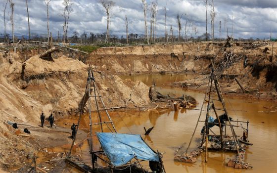 Peruvian police take part in an operation to destroy illegal wildcat gold mining camps in a zone known as Mega 14, in the southern Amazon region of Madre de Dios, Peru, Jan. 19, 2018. (CNS/Reuters/Janine Costa)