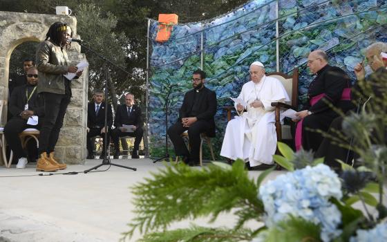 Pope Francis listens as migrant Daniel Jude Oukeguale speaks of his harrowing journey leaving Nigeria, during a meeting with migrants at the John XXIII Peace Lab in Hal Far, Malta, April 3, 2022. (CNS photo/Vatican Media)