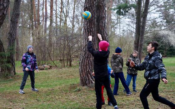 Ukrainian children from a group home for orphans in Zhytomyr, Ukraine, play in the yard of the motherhouse of the Congregation of the Sisters of the Angels April 20 in Konstancin-Jeziorna, Poland. (CNS/Adrian Kowalewski)