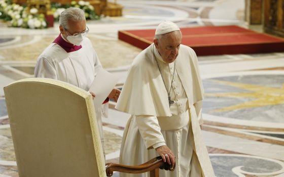 Pope Francis arrives at his seat as he participates in Mass marking the feast of Divine Mercy in St. Peter's Basilica at the Vatican April 24, 2022. (CNS photo/Paul Haring)