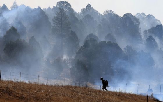 A firefighter near Las Vegas, N.M., works to combat the Hermits Peak and Calf Canyon wildfire May 4, 2022. (CNS/Reuters/Kevin Mohatt)