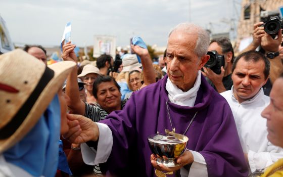 Cardinal Mario Poli of Buenos Aires, Argentina, distributes Communion during a Mass outside the Basilica of Our Lady of Lujan in Buenos Aires March 8, 2020. (CNS photo/Agustin Marcarian, Reuters)