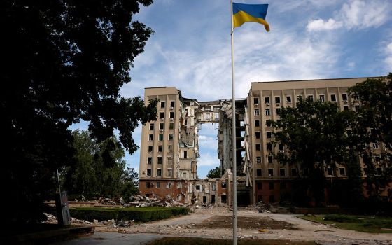 A Ukrainian flag flies in front of the destroyed regional administration building following shelling by Russian troops June 8 in Mykolaiv, Ukraine. (CNS/Reuters/Edgar Su)