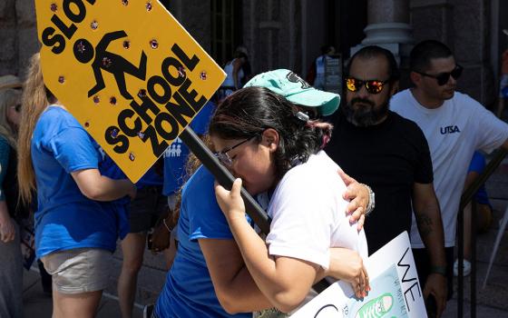 Jazmin Cazares, 17, right, the sister of Jackie Cazares, who was killed in the May 24 mass shooting at Robb Elementary School in Uvalde, Texas, gets a hug from Mary Morales of Kyle, Texas, June 11 during a March for Our Lives rally in Austin, Texas. (CNS)