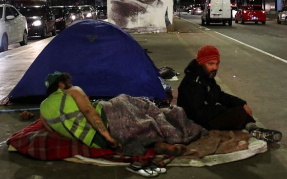 Homeless men sit along a street in São Paulo June 11, 2022. (CNS/Reuters/Amanda Perobelli)