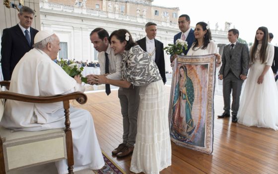 Pope Francis greets newly married couples during his general audience in St. Peter's Square at the Vatican May 4. (CNS/Vatican Media)