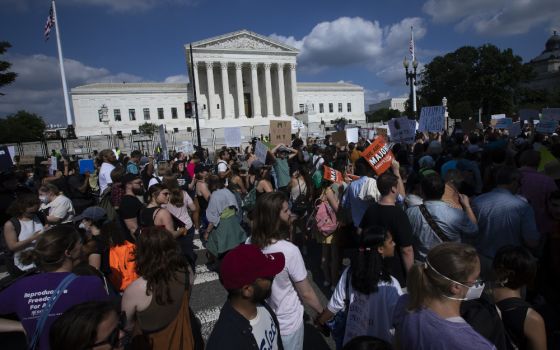 Abortion demonstrators are seen near the Supreme Court in Washington June 24 as the court overruled the landmark Roe v. Wade abortion decision in its ruling in the Dobbs case on a Mississippi law banning most abortions after 15 weeks. (CNS/Tyler Orsburn)