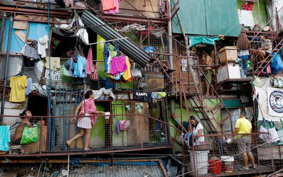 Residents are pictured outside their homes May 4, 2020, in a poor section of Manila, Philippines. (CNS/Reuters/Eloisa Lopez)