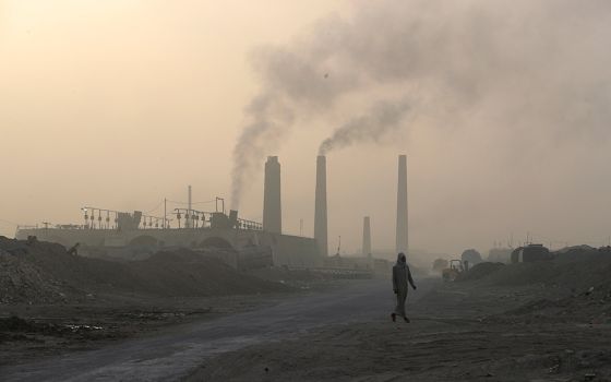 A general view shows brick factories as smoke rises from the stacks in the town of Nahrawan June 5 in Baghdad, Iraq. (CNS/Reuters/Thaier al-Sudani)