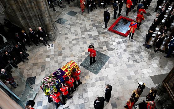 Pallbearers carry the casket of Queen Elizabeth II with the imperial state crown resting on top into Westminster Abbey during her state funeral Sept. 19 in London. (CNS/Gareth Cattermole, pool via Reuters)