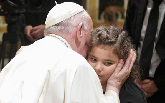 Pope Francis greets a child during an audience with members of the Fraternity of St. Thomas Aquinas Groups from Argentina in the Vatican's Clementine Hall Sept. 30, 2022