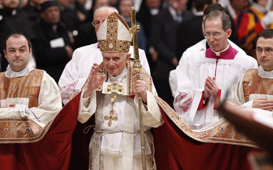 Pope Benedict XVI waves as he leaves after celebrating vespers with members of religious orders in St. Peter's Basilica at the Vatican on Feb. 2, 2011, the feast of the Presentation of the Lord and the World Day for Consecrated Life. (CNS/Paul Haring)